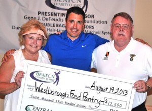 Accepting a check for $12,500 from state Rep. Matt Beaton, R-Shrewsbury (center), on behalf of the Westborough Food Pantry are (l to r) Wendy Mickel, the food pantry's treasurer, and Westborough Selectman Denny Drewry, a member of the Beaton Charity Golf Classic Planning Committee. Checks were also accepted on behalf of St. Anne's Human Services by Elaine LeBlanc, the director, and JoAnn Keegan, the food bank manager; and on behalf of Shrewsbury Youth and Family Services by Terry Cassidy, the executive director.