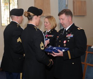 Landstuhl Regional Medical Center Honor Guard members present folded American flags to Col. John P. Collins, right, and Col. Nancy J. Hughes during their retirement ceremony May 22.  Photo/courtesy U.S. Army