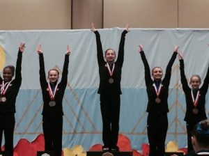 Shrewsbury resident Olivia Zona stands atop the podium after winning the Eastern National Junior 7 floor competition. (Photo/submitted)