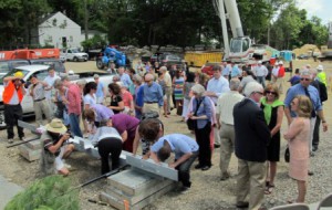A crowd of donors, volunteers and library staff sign the final beam for the new library before a crane lifted it into place. (Photos/Joyce DeWallace)