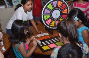 Girls try their luck at a spinning wheel game.