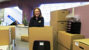 Nancy Colby, head of circulation, packs and stacks boxes of everything needed for basic library operations from the main front desk.