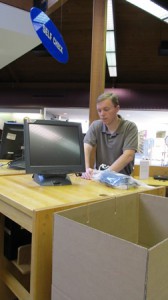 The Electronics Resources Librarian Mike Zeller cradles the computers and all their components for the move.