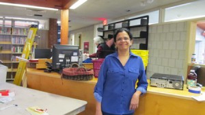 Priya Rathnam, assistant library director, stands in front of what will be the new circulation desk for the next two years as the staff works diligently to complete the move and reopen.