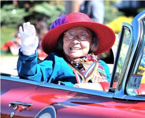 Longtime community volunteer Isabelle Chang is honored as grand marshal as she rides in style in the 1959 Cadillac convertible formerly owned by Lucille Ball.