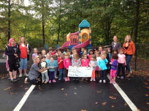 Teachers and students of God’s Little Children Preschool and Kindergarten in Shrewsbury hold the check for St. Jude’s.