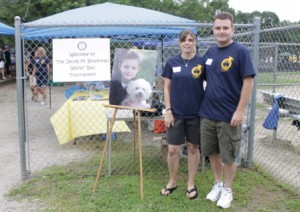 Jacob's parents, Kristen and Jim Boudreau, stand at the entrance of the fifth annual Jacob M. Boudreau Memorial Wiffle Ball Tournament.
