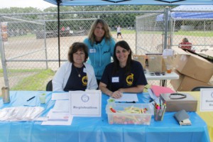 Friends of the Boudreau family (l to r) Linda, Lesley and Karen, volunteer at the tournament's registration booth. 