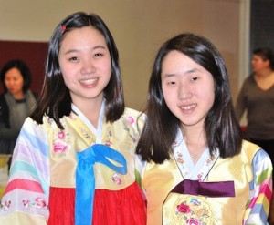 Ninth-graders Elaine Moon and Annie Lee wear hanboks, a traditional Korean outfit.