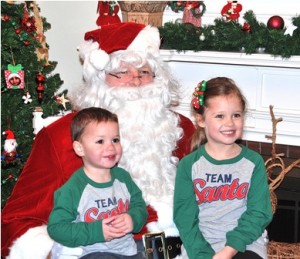 Santa poses for a photo with Cole Triompo, 2, and his sister, Isabella, 4.