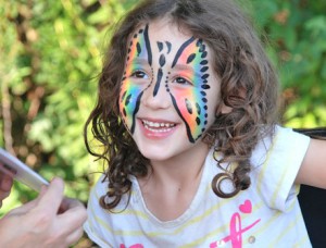 Hayden Peak, 4, is pleased with the mirror reflection of her painted face.
