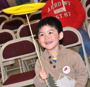 Following the circus show, Eric Zhang, 4, learns how to balance a plate.