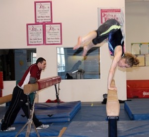 Chloe Herczeg practices on the balance beam. (Photo/Rebecca Kensil)