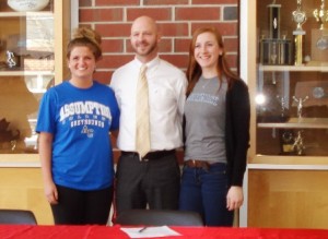 Hudson High School athletes Nicole Sloan (left) and Nicole Mooar, with Coach Spencer Fortwengler, signed letters of intent to continue playing sports at Massachusetts colleges. Photo/Eduardo Cuan