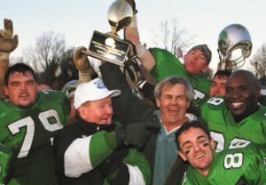 Bob Brennan (front, wearing hat) celebrates a championship in 1998 with sponsor Bob Kays and the Marlboro Shamrocks football team. (Photo/Eric Baur)