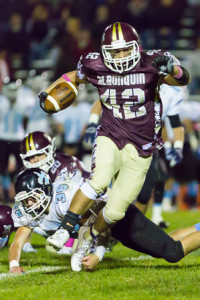 Algonquin junior Max Cerasoli avoids a tackle by Holy Name’s Dylan Diorio.