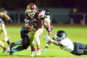 Algonquin’s Billy Polymeros is tackled by several Holy Name defenders.