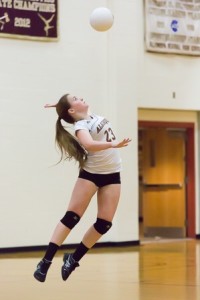 Algonquin junior Kristen Cooley leaps into the air as she serves the ball.