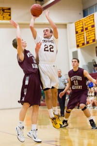 Algonquin’s Joe Wallace (#22) leaps up to shoot over the head of Westford’s Daniel Cornelius.