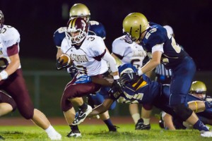 Algonquin junior Billy Polymeros (#3 in white) tries to evade tackles from several Shrewsbury defenders. 