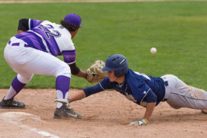 Shrewsbury’s Mike Filiere dives back to first to avoid the pickoff throw to St. Peter Marian’s Jon Gonzalez.