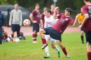 Westborough's Mickael Buswell (#17, red) and St. John's Sean Foley (#2, white) fight for the ball.