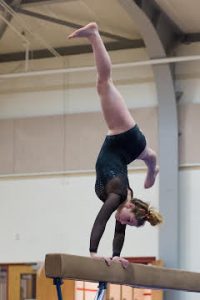 Marlborough's Abbie McNickol performs a hand stand with a split on the balance beam.