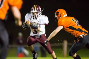 Algonquin’s junior Billy Polymeros (#3) tries to avoid a tackle by the Marlborough’s Joe Tirpack (#14)