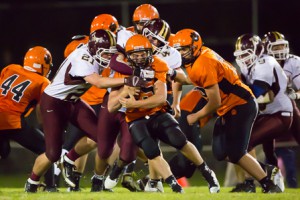 Marlborough’s running back Willy Cowdrey(#25) is tackled by the Algonquin’s Thomas Polutchko (#21) and John Clark IV (#44) 