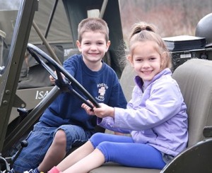 Four-year-old twins Blake and Brookelyn Sullivan get behind the wheel of a 1951 Korean War quarter-ton jeep.