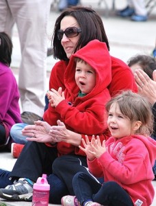 Applauding for the magic show are Nicole MacLennan and her 3-year-old twins, Liam and Kiera.