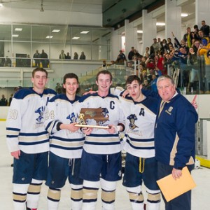 The Shrewsbury High School boys' hockey Central Mass Division 3 2014 champions pose with their trophy, from left to right: Cole Ambach (#20), Cole Vincequere (#24), David Belbin (#25), Derric Dell'Olio (#6) and Head Coach Stephen Turnblom. 