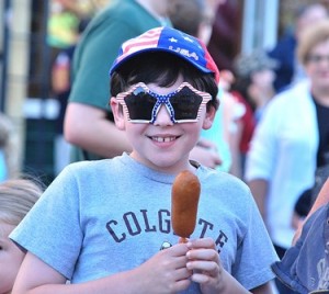 Vincent Zito, 8, is treated to patriotic souvenirs and a corndog at last year's celebration.  File photo/Ed Karvoski Jr. 