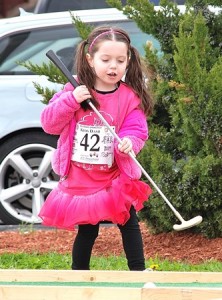 After participating in the Kids Dash. Jaelynn, 4, plays miniature golf.