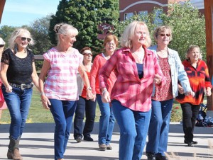 Mary Dragon of Northborough (front), choreographer and manager of the Country Kickers, leads a line dance with her students from senior centers in Hudson, Northborough and Westborough.