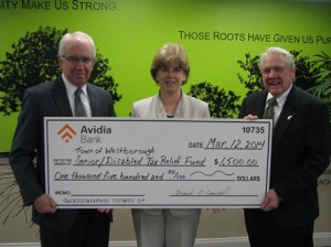 Joseph MacDonough (left) and Paul McGrath (right), directors at Avidia Bank, present the check to Joanne L. Savignac, Westborough treasurer. (Photo/submitted)