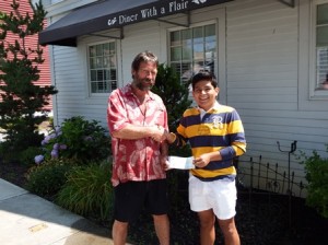 Mark Sullivan, owner of the South Street Diner, congratulates Brian Pu Ruiz on winning the diner's annual scholarship. (Photo/Bonnie Adams)