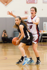 Marlborough’s Halle McCabe (#14) looks to pass to a teammate while being guarded by Westborough’s Julie Hutchinson (#15).