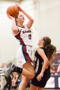 Westborough’s Haley Brown (#13) goes up over Marlborough’s Halle McCabe (#14) as she shoots a basket.