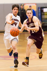 Algonquin’s Kyle Henderson races down the court as he is pursued by Westborough’s Anthony Casparriello