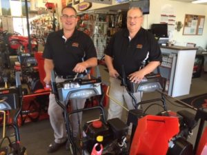 Rick Simonovitch (l) and Garrett Bake, salesmen at Boston Lawnmower Company, stand with some of the 2016 Ariens Snow Thrower lineup. Photo/submitted 
