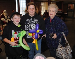 : Jacob Haskell, 10, holds a king cobra balloon sculpture. He is shown with his mother, Cindy Haskell, and his grandmother, Carol Haskell. 