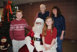 Bob Knight shares a moment with Santa, his daughter Beth Felton and his grandchildren Brooke, 9, and Hunter, 10.