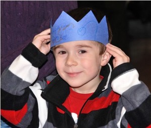 After learning about the Latin American celebration of Three Kings Day, Nathaniel Bixby, 5, tries on the crown he created.