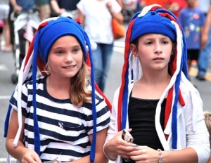 Madison Bromm, 11, and Cecilia Goetz, 10, sport headdresses they purchased at last year's block party.