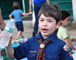 Elijah Mecenas, 10, sells cold bottled water on behalf of Cub Scout Pack 33.