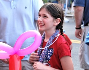 Hailey Ancello, 8, is happy to receive a sculpted balloon from children's entertainer Fran Flynn.