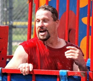 Coach Tim Keddy gets dunked in the tank from a good shot by a young pitcher.