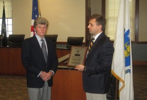 Kenneth Ferrera presents a plaque honoring Howard K. (Pete) Fay Jr. to Fay’s brother, Carroll F. Fay.