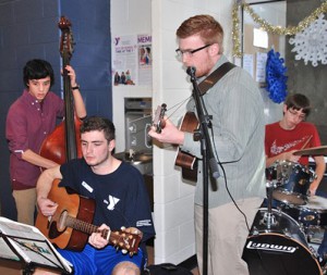 Playing holiday music are Algonquin Regional High School students (l to r) Spencer Cardillo, senior, and juniors Michael McCormack, Henry Fournier and Trent Jones.